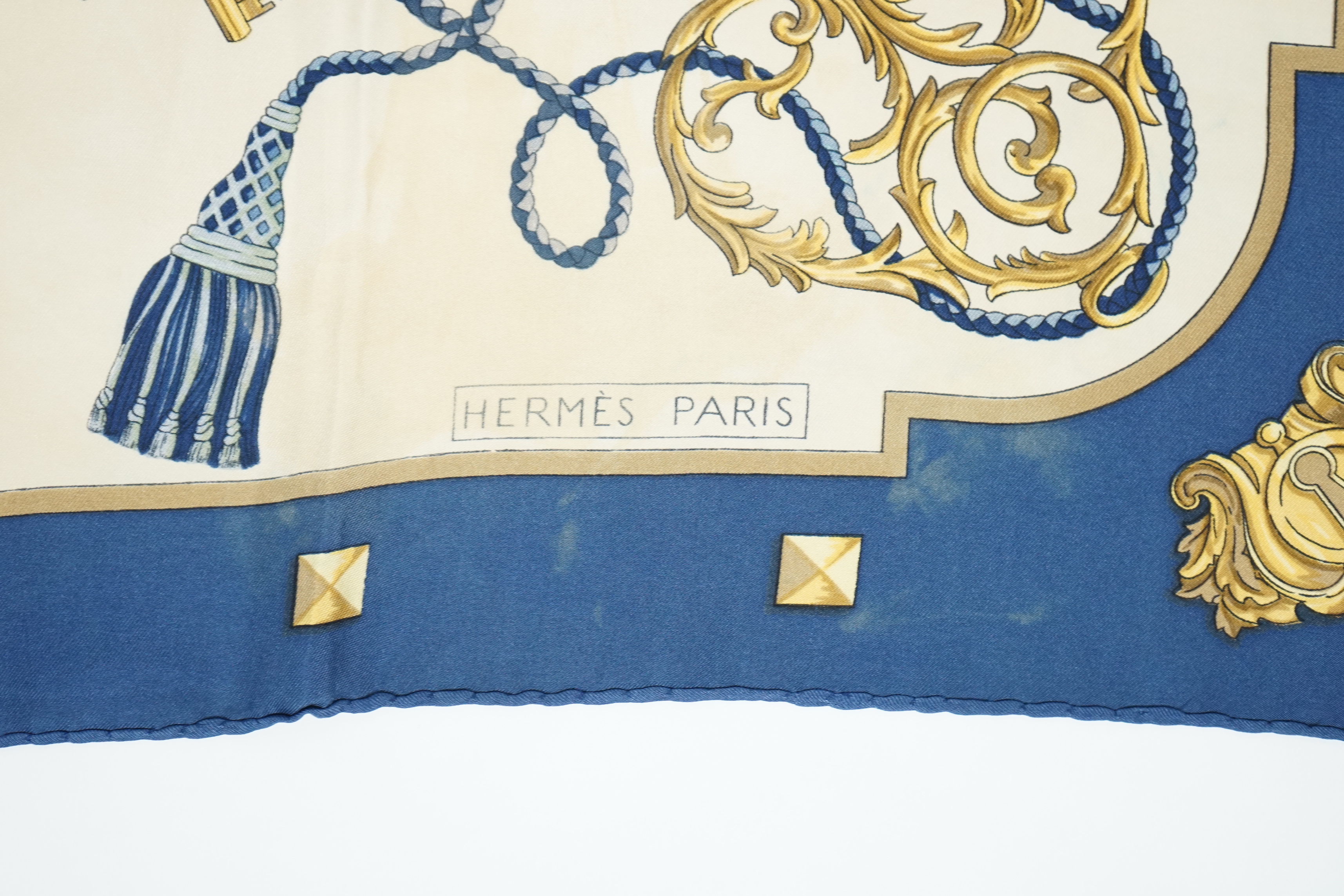 A Hermès 'Les Cles Key' blue border multicolour silk scarf and a Hermès Lhiver blue, white and gold silk scarf, both 90cm x 90cm